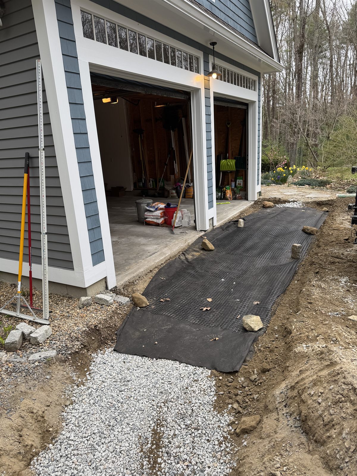 Geotextile fabric laid against a home foundation before stone — GSS drainage project