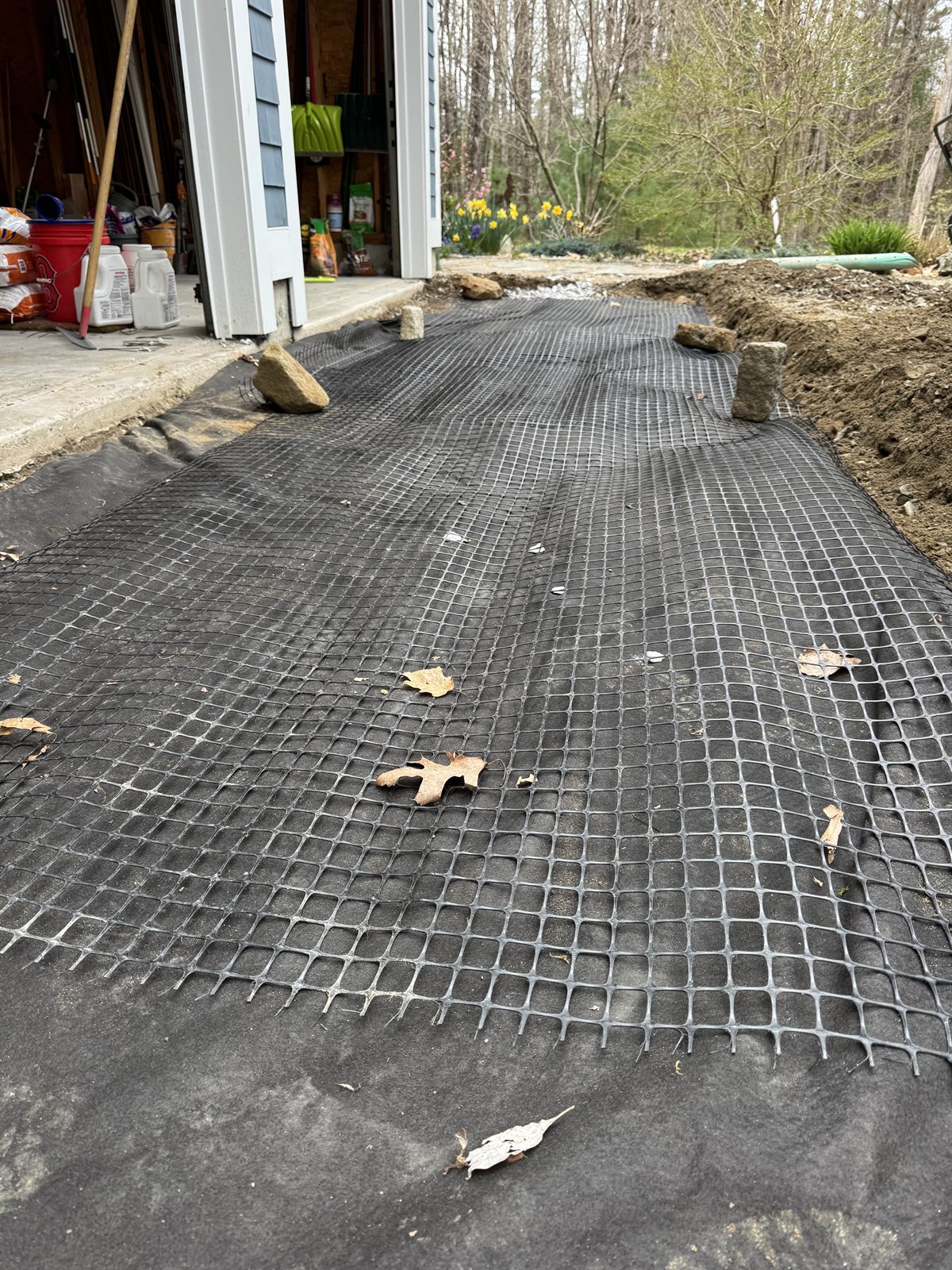 Geogrid reinforcement over stone in a drainage installation — GSS, Seacoast NH