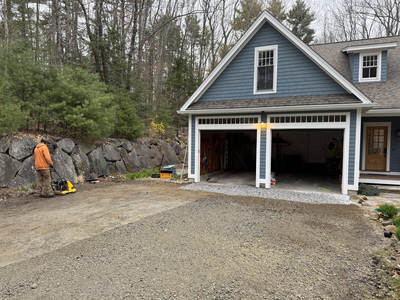 Regrading and plate-compacting the gravel apron during foundation drainage work — GSS, Seacoast NH