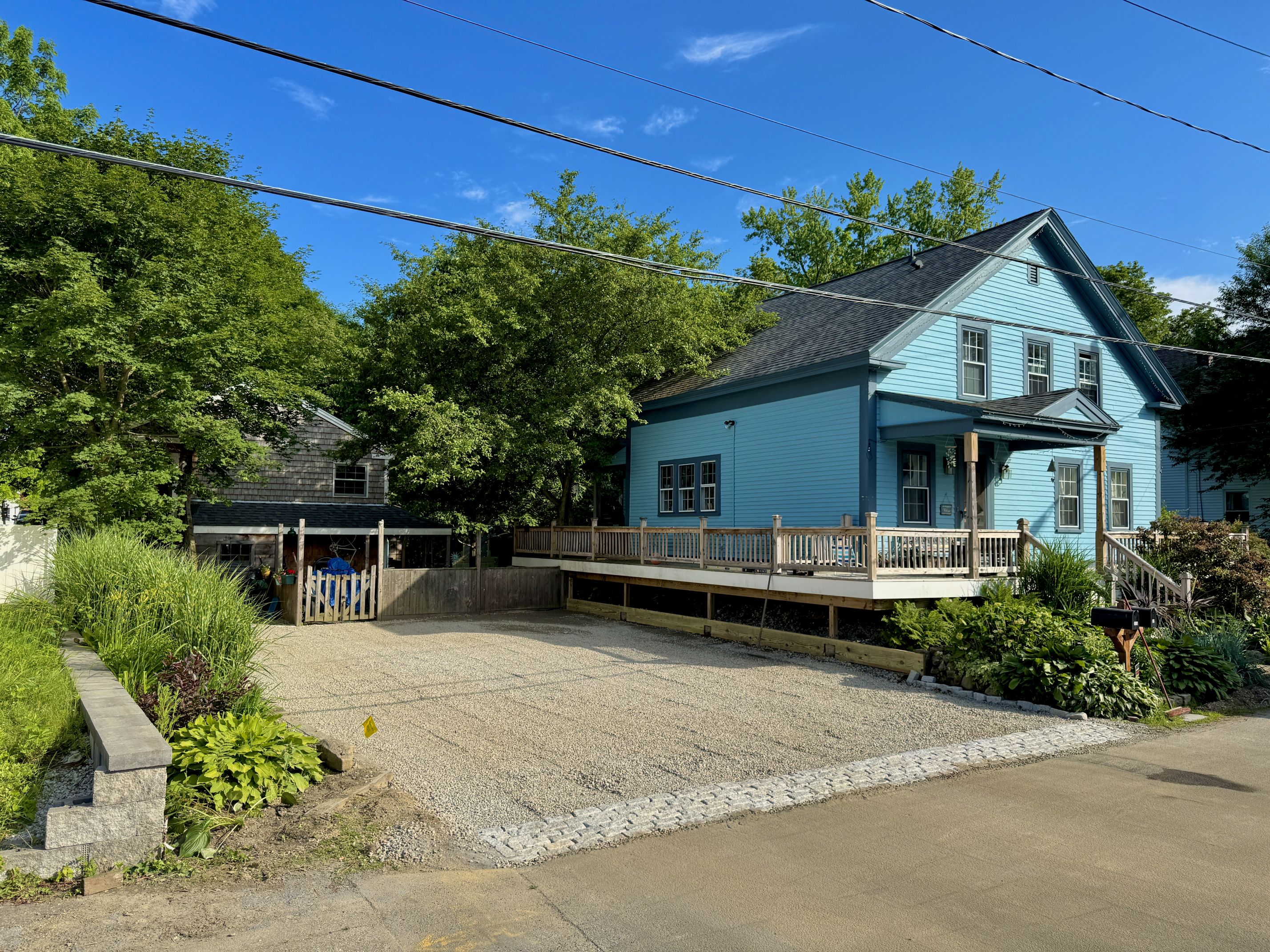 Completed gravel driveway with paver border and proper grading — GSS project, New Hampshire